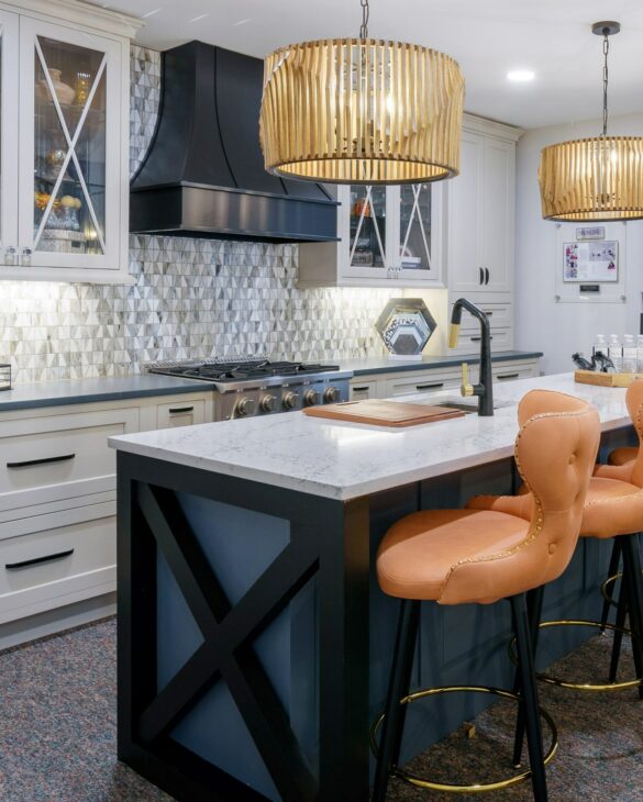 white, black, blue, and gray kitchen with statement pendant lights featuring a black Hoodsly Curved hood with strapping and flat trim