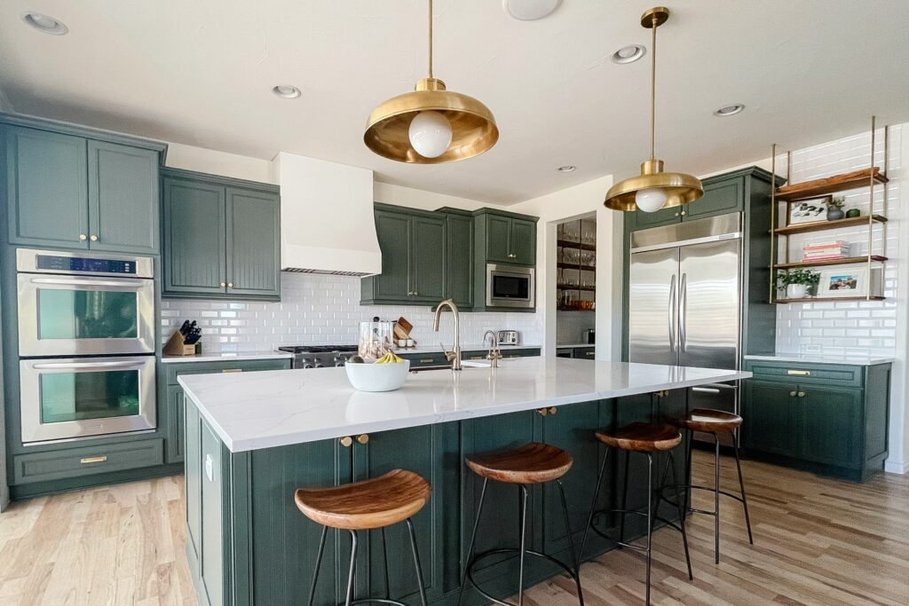 green and white kitchen with gold and natural wood accents featuring a white Hoodsly sloped hood without trim 